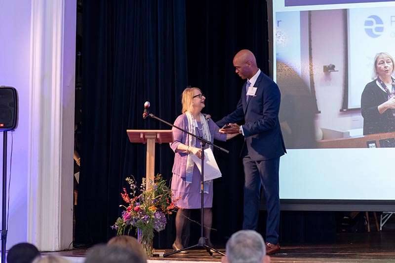 Mary Dedinsky accepting Medill Hall of Achievement award