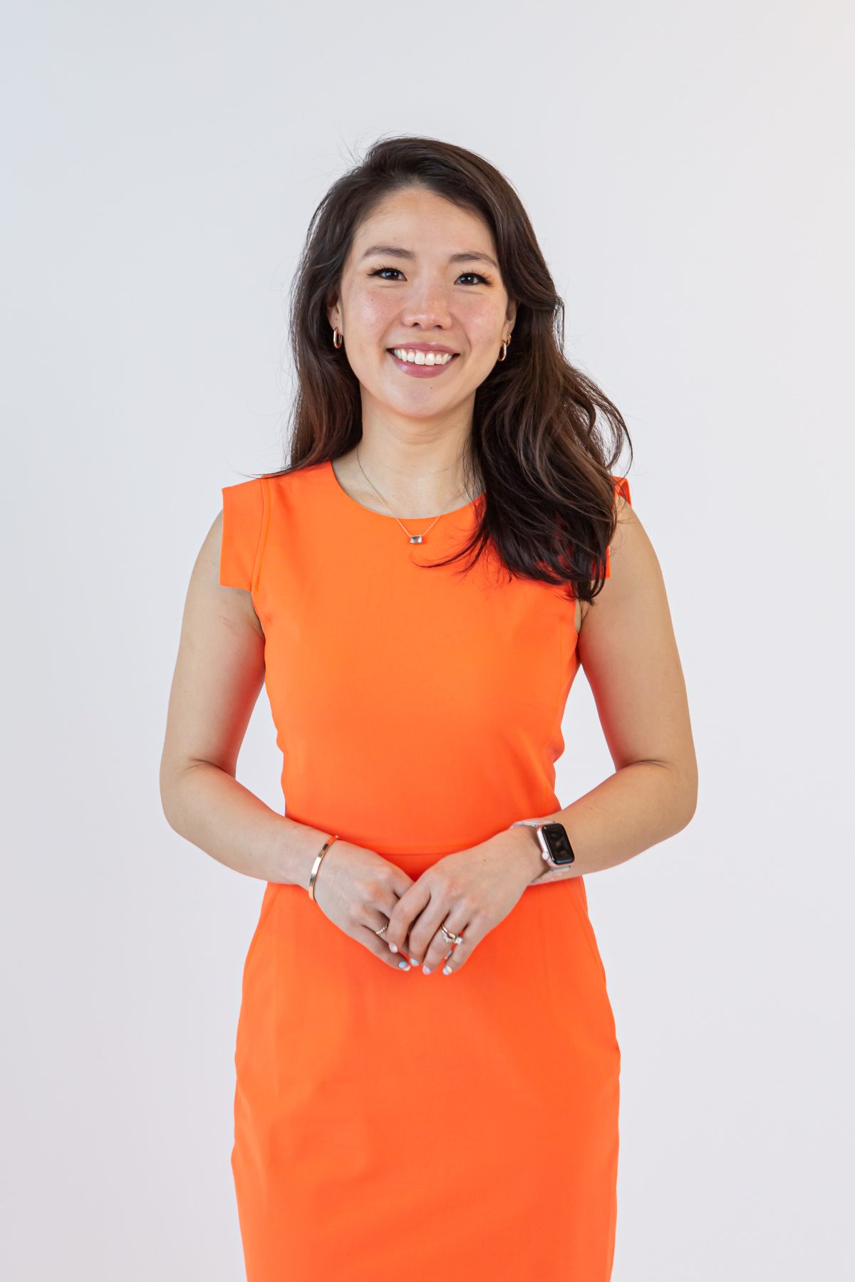 Sharon Yoo in orange dress.