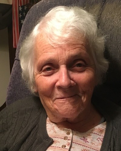 Elderly woman with white hair, smiling